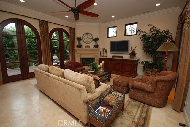 Large family room with ceiling fan and fireplace