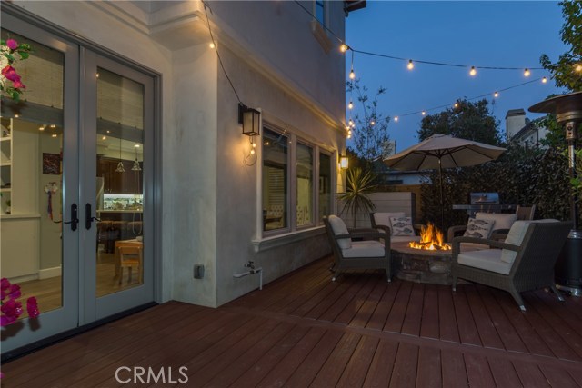 Another dusk view of the backyard deck with firepit.