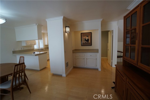 Dining room, kitchen, serving bar alcove.