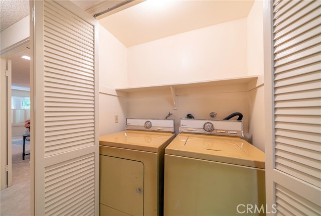 Washer and Dryer is tucked away and hidden in closet in the hallway.