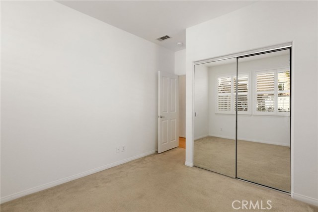 The mirrored closet in the downstairs bedroom.