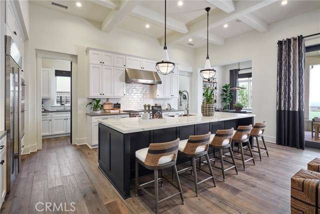 Gourmet chef's kitchen featuring Wolf & Subzero appliances, kitchen island, 2nd prep kitchen and dining nook.