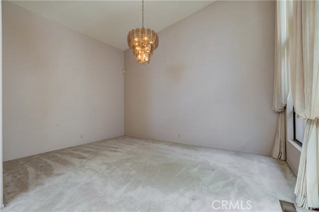 Formal Dining Room off of kitchen with tall windows and custom curtains