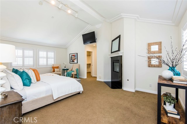 Huge master bedroom with multiple areas for seating or dressing.  View into walk-in closet.