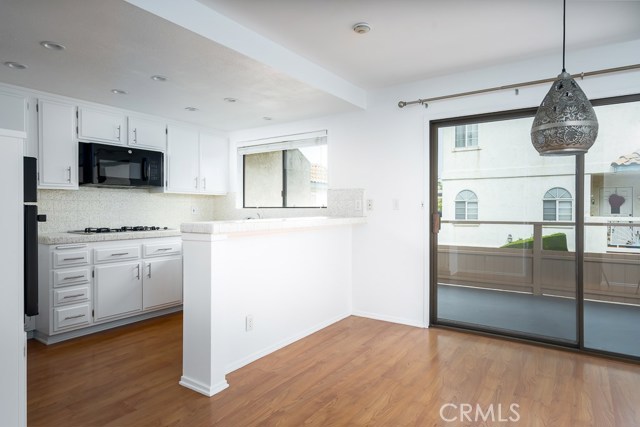 Dining area and kitchen.  Sliding door to lower deck.  Freshly painted with new light.