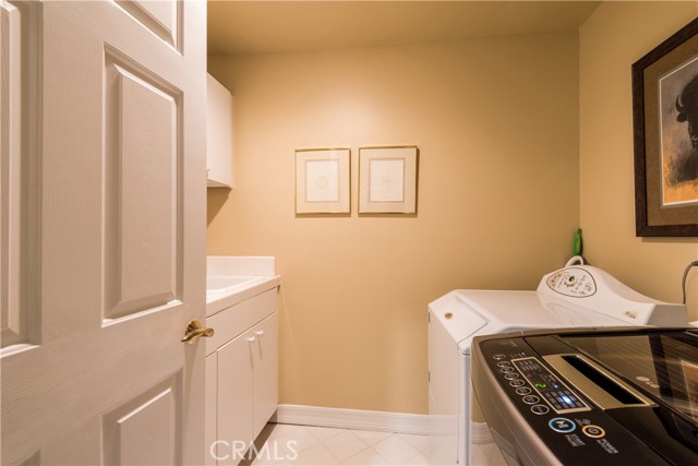 Full Size laundry room with sink and storage area