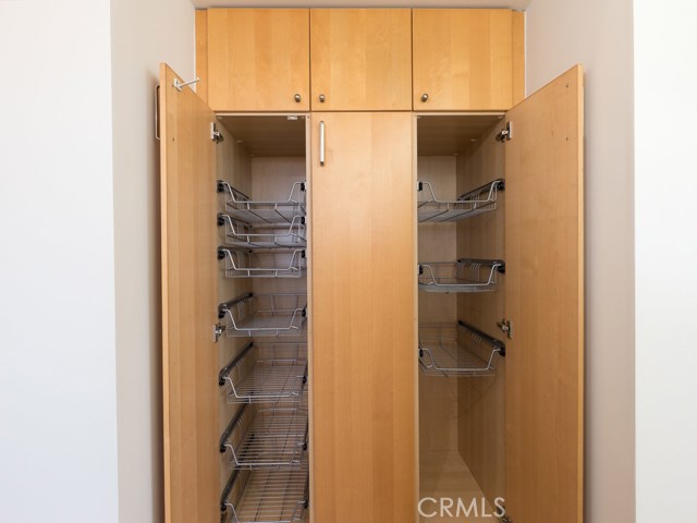 Built-in pantry across from kitchen