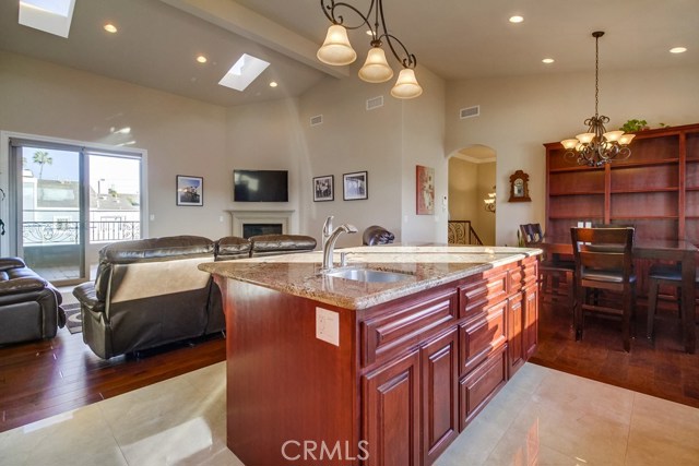 Built-in bookcase creates a nice focal point in the dining area and beamed ceiling and more skylights add additional touches.