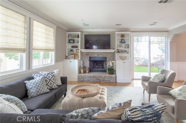 custom built ins surround fireplace and living area