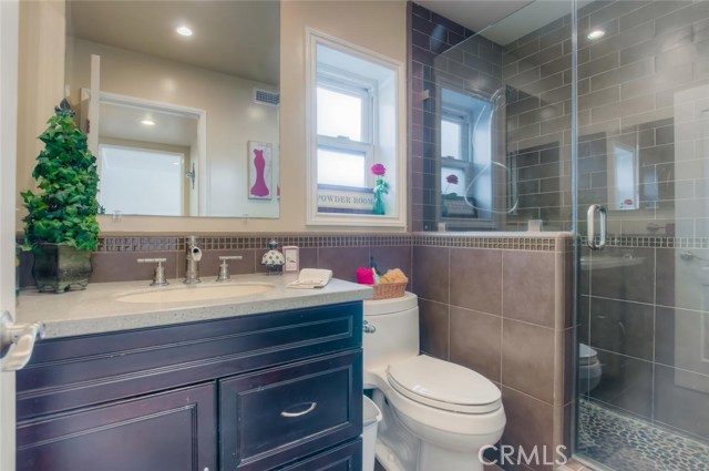 The main floor bathroom sits off the hallway from the dining room, between the two bedrooms on the main floor.