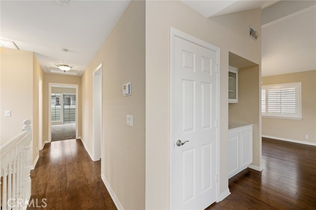 View from up stairs hall way leading to kitchen, half bath and master - Then to the living room.