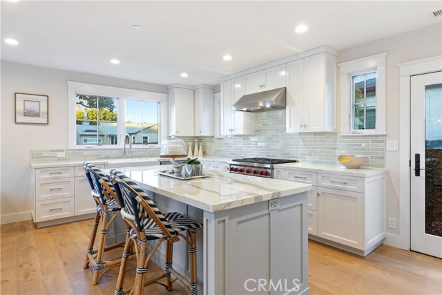 The show-stopping kitchen is upgraded to perfection with custom cabinetry and island by His Life, a built-in Sub-Zero refrigerator and Suz-Zero wine fridge, Wolf 6-burner range, countertops by Neolith, and thoughtful conveniences where no detail has been spared.
