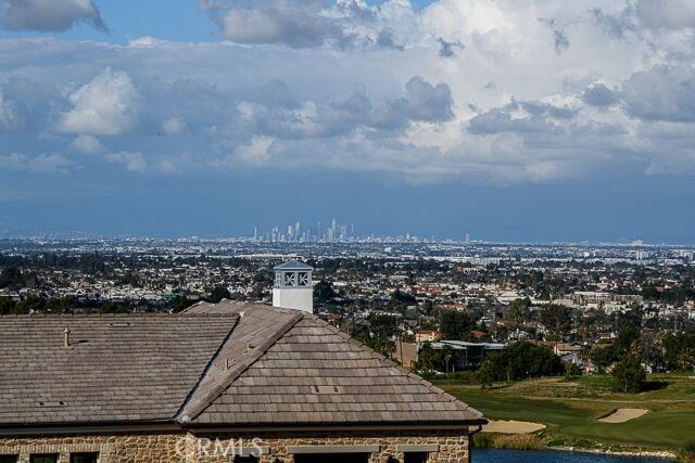 View of Downtown L.A. & private golf course from the backyard of this home.