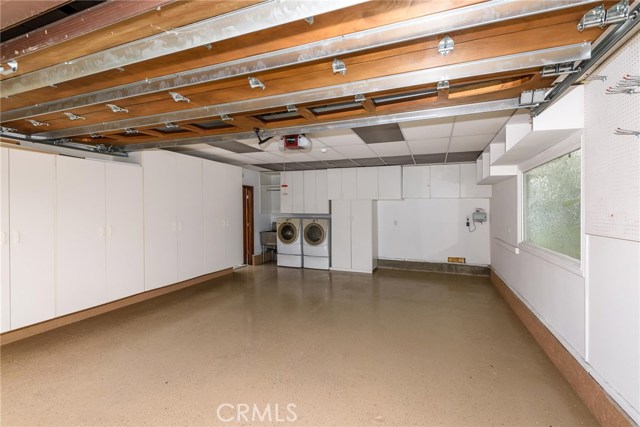 2 car garage with lots of custom cabinet space, utility sink and epoxy surface.