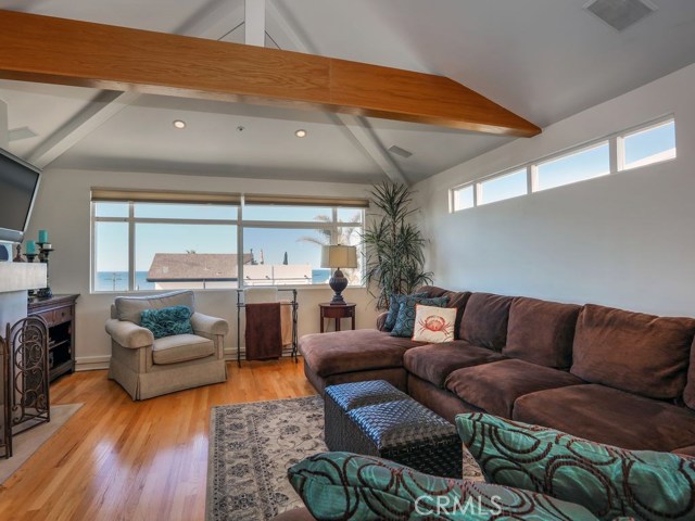 10 Foot ceilings in this ocean view living room, complete with fireplace, make it the perfect place to unwind or gather friends.