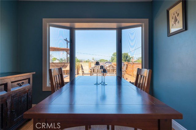 Dining room with bay window looking out at rear deck and horizon views.