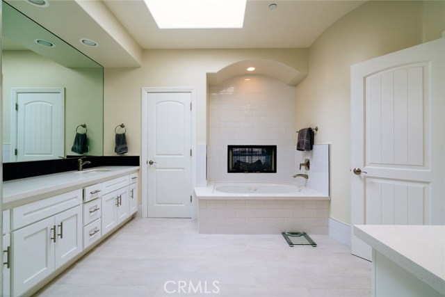 Master bath, with see-through fireplace connecting to the bedroom.