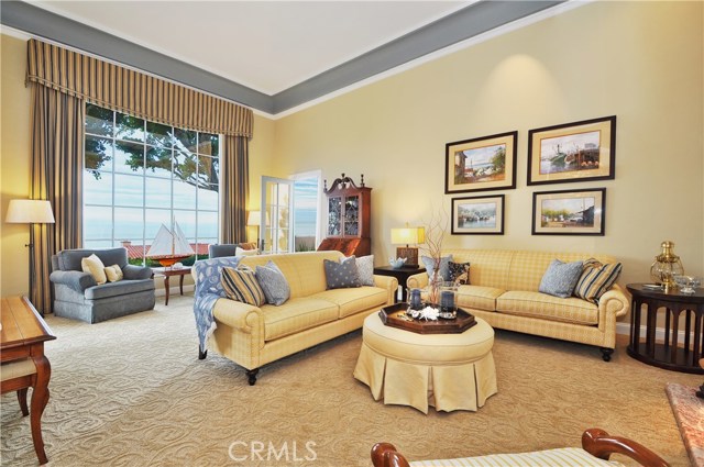 Living Room with Cathedral ceiling and Ocean View, note access to private terrace.