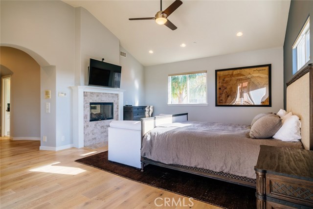 Master bedroom sanctuary, with fireplace and tall ceilings.