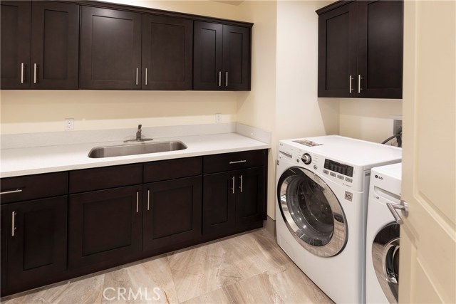 Laundry Room w/sink, built-in ironing board, and ample storage