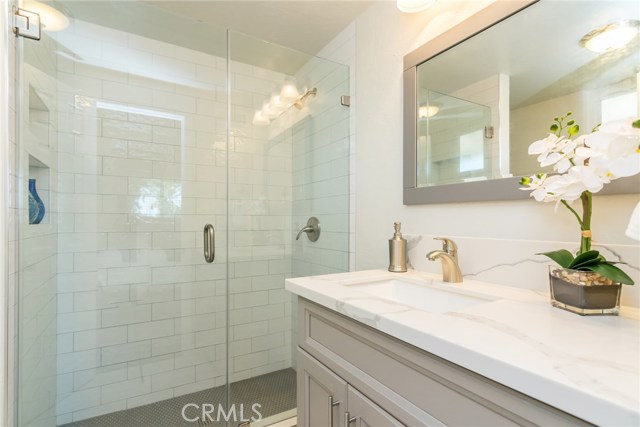 The master bathroom with all new custom glass doors, new subway tile surround and new tile flooring. There is a new vanity and toilet, too.