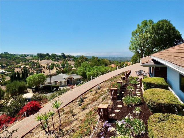 The home is nestled on a hillside overlooking the neighborhood