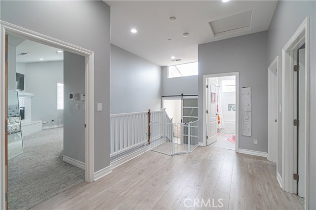 View of door to master-suite on the left, straight ahead staircase, upstairs bathroom and additional bedrooms on the right hand side