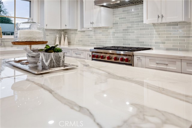 Gleaming Neolith, Polished Estauario counter top is the elegant foundation and a highlight of the kitchen.