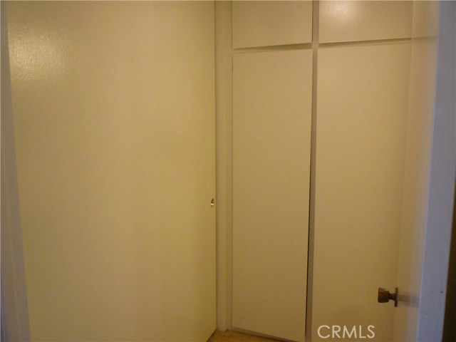 Small hallway with two closets just adjacent to the bathroom.