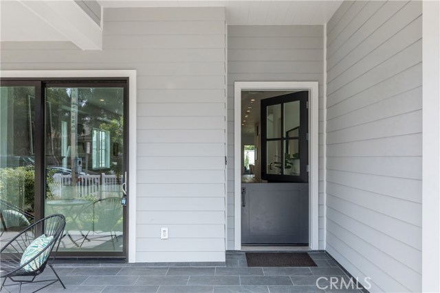 Sliding French doors that invite the living room outdoors as well as a delighful and welcoming Dutch door