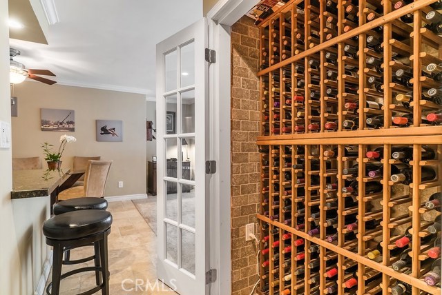 A custom built wine closet with built-in wine racks for 200+ bottles, which is insulated with Travertine floors, walls and ceiling. 
