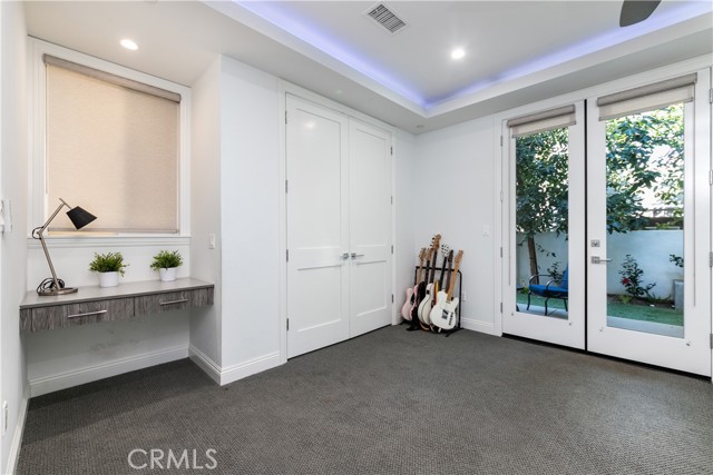 Storage, built-ins and French doors finish off this lower level bedroom