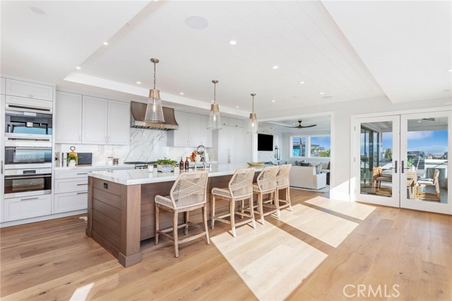 Gourmet Kitchen with 12 foot island featuring neolith counters, wolf range, sub zero fridge, 2 dishwashers and a built in Miele coffee maker.