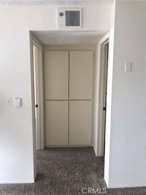 Storage cabinets located between the bedroom and bathroom