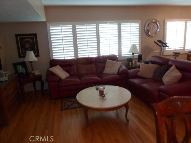 Living area with plantation shutters. Hardwood floors troughout. Living area with plantation shutters. Hardwood floors troughout.