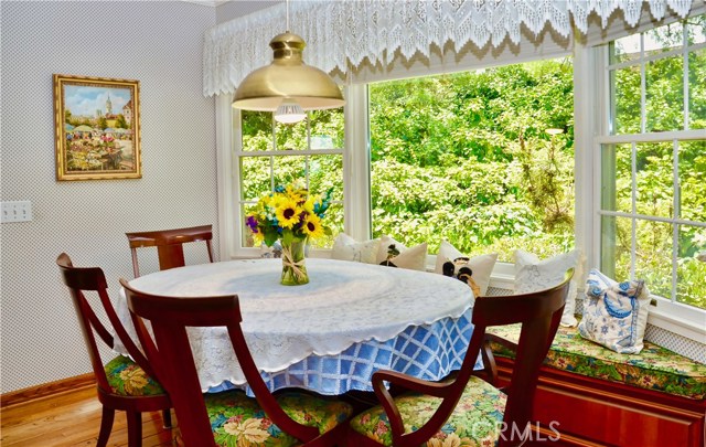 Dining area off of the kitchen with window seat and large sunny windows.