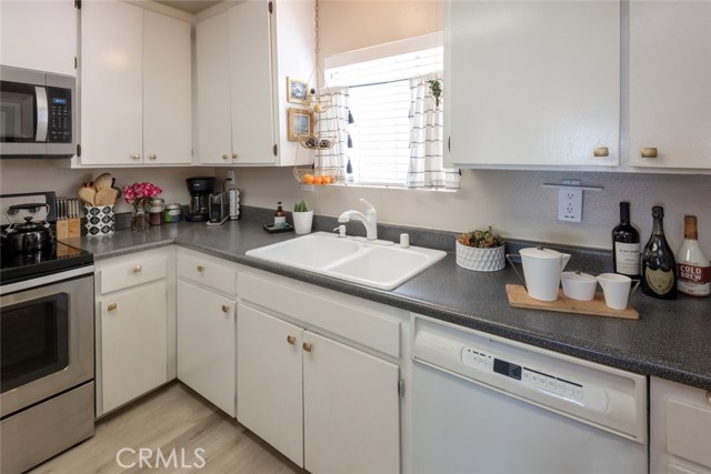 The kitchen includes a free-standing range and oven, microwave, dishwasher and newer stainless refrigerator.
