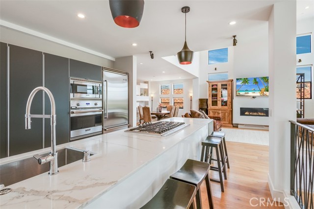 Entertainers dream kitchen with quartz counters, sleek cabinetry with hidden power outlets and upgraded Viking Professional appliances