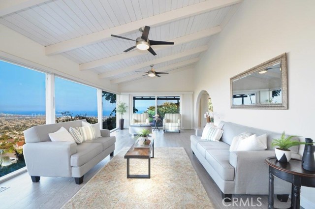 Bright & Airing Living Room has High Ceiling & Walls of Glass