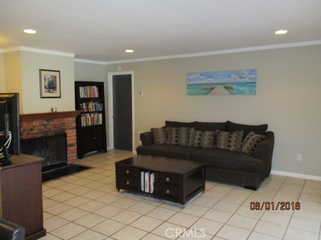 Large living room with fireplace and access to balcony.