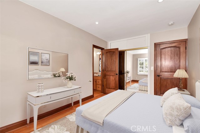 Third bedroom with plantation shutters, refinished wood floors, mirrored closet doors and direct access to a half bath.