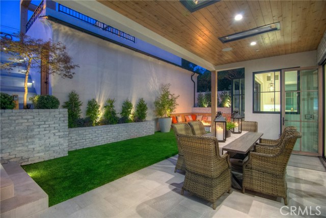 Private backyard, fire pit with seating, low maintenance artificial turf, covered patio with built-in heaters, sandblasted marble floor tiling, LaCantina door systems for the perfect indoor/outdoor experience, surround sound.  Adjacent 3 car garage with guest/in-law suite above the garage.