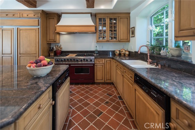 Antique Finish Alder Cabinets Elegantly Paired with Granite