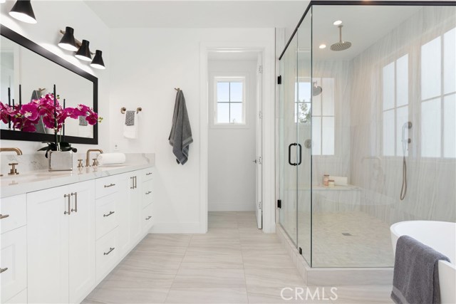 Master bathroom with double shower and custom dual vanities