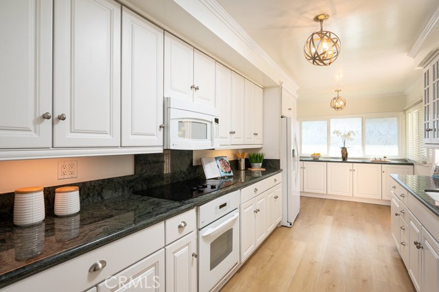 Granite counters and lots of natural light and storage in this kitchen.