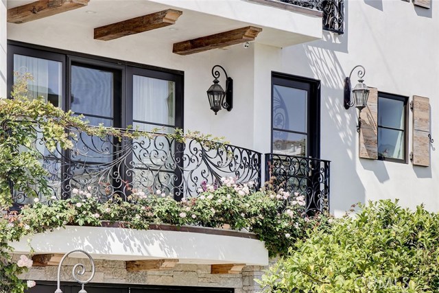 Wrought iron railings, reclaimed barnwood corbels, decorative window shutters