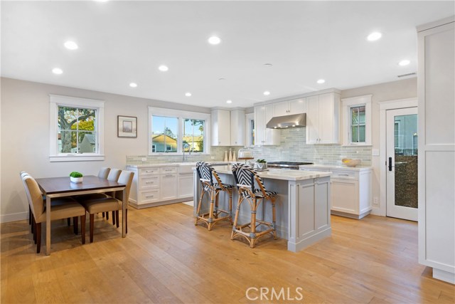 The bright and open great room includes custom wide plank French oak floors and wainscoting that bring warmth and character to the space.