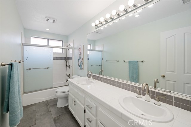 Hallway full bathroom with double sinks