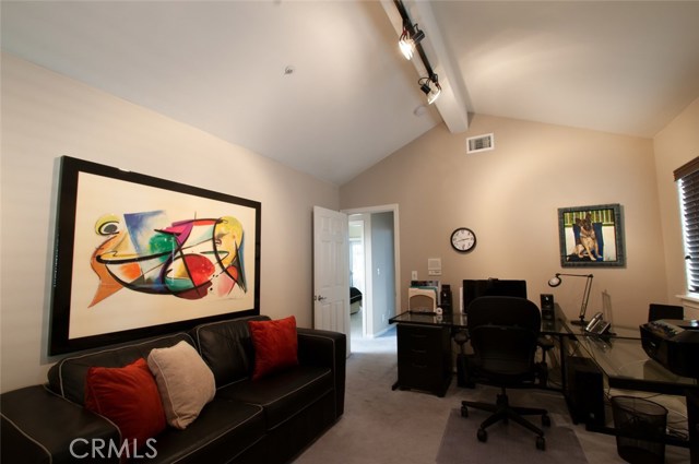 Guest Bedroom #2 with beamed high vaulted ceiling. Used as an office.