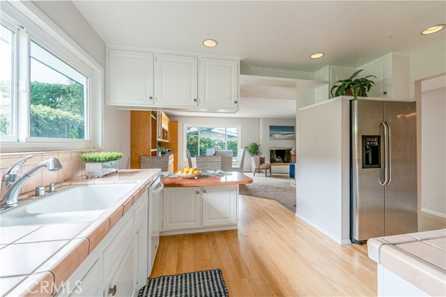Kitchen looking into dining family room area with fireplace